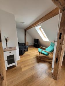 a living room with a couch and a chair at Lauberhof in Trippstadt