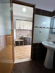 a bathroom with a shower and a sink and a toilet at Vila Riviera in Ksamil