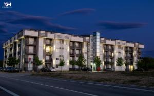 a building on the side of a street at night at Apartman Goga 2 in Veliko Gradište