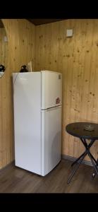 a white refrigerator and a table in a room at Shulgivka in Shulʼgovka