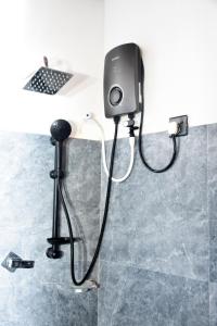 a shower in a bathroom with a shower head at Miu Villa in Ahangama