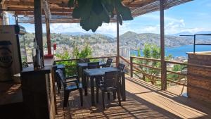 a table and chairs on a balcony with a view at Denis Apartments in Sarandë