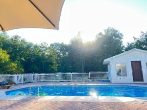 a swimming pool in front of a white fence at The Great Escape in Clintondale