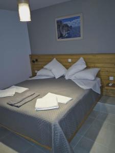 a bed with white towels on top of it at Ionian Balcony II in Athani