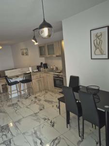 a kitchen with a table and chairs and a dining room at Ionian Balcony II in Athani
