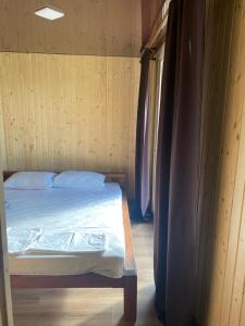 a bedroom with a bed in a wooden wall at Shulgivka in Shulʼgovka +66 photos
