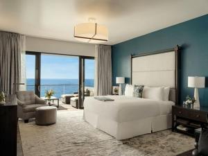 a bedroom with a large white bed and a living room at The Loren at Pink Beach in Tuckerʼs Town +89 photos