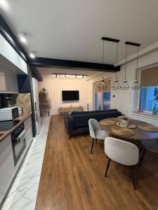 a living room with a table and a couch at Katerina - Mona Luxury Apartments in Lębork