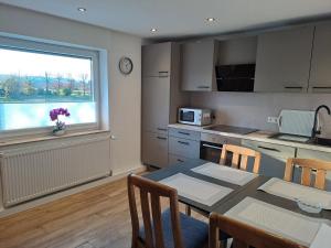 a kitchen with a dining table and a window at Ferienhaus Bielefeld in Bielefeld +21 photos