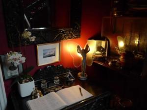 a desk with a lamp and an open book at Villa Rothsay Hotel in Cowes
