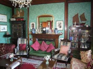 a living room with a couch and chairs and a mirror at Villa Rothsay Hotel in Cowes +5 photos