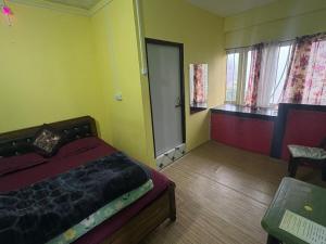 a bedroom with a bed and a room with a door at Fun Viewpoint Homestay Darjeeling in Darjeeling +1 photo