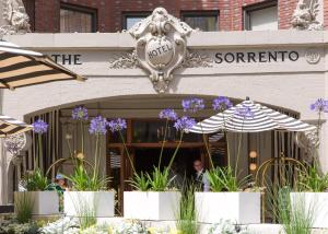 a restaurant with umbrellas and flowers in front of it at Hotel Sorrento in Seattle