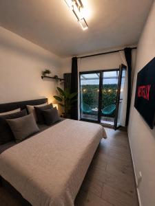 a bedroom with a large bed and a large window at La Suite Hotel - Self Check-in in Hanau am Main