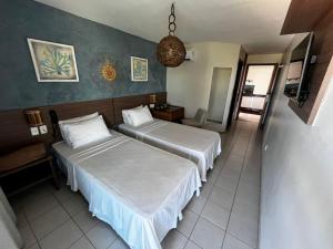 a hotel room with two beds and a room with at Samba Villa da Praia in Salvador +62 photos
