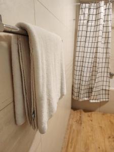 a bathroom with white towels hanging on a towel rack at Premium 2 Bedroom Apartment Near Airport in Muscat