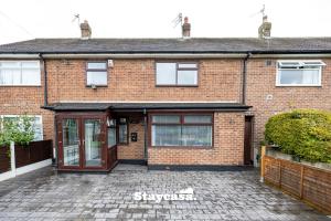 a brick house with a driveway in front of it at Spacious Cosy Cove with Large Driveway and Garden in Wythenshawe