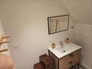 a bathroom with a sink and a mirror on the wall at Home Gãyatri in Angé +49 photos