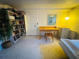 a room with a table and a book shelf at Cozy and Spacious Guest Room, Virum in Virum +12 photos