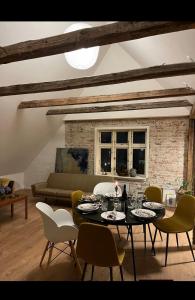 a living room with a table and chairs and a couch at Kroghuset - Det Lille Hotel in Tarm