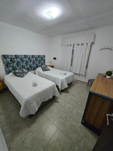 a hotel room with two beds and a television at Veronica mini home 1 in Verónica