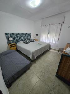 a bedroom with two beds in a room at Veronica mini home 1 in Verónica +4 photos