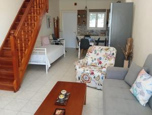 a living room with a couch and a table at Galini in Mytikas