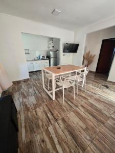 a table and chairs in a room with a kitchen at Veronica mini home 1 in Verónica