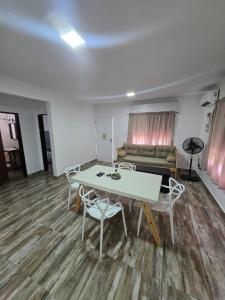 a living room with a table and chairs and a couch at Veronica mini home 1 in Verónica