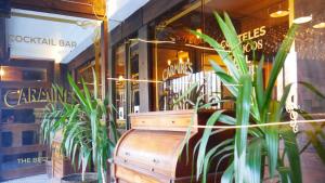 a bench in front of a restaurant with plants at Hotel Sonetto in Santiago