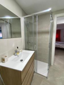 a bathroom with a sink and a shower at Apartamento con vistas a la Playa con Ascensor y WIFI 9 pax in Daimuz +45 photos