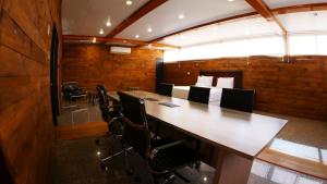 a conference room with a large wooden table and chairs at Hotel Sonetto in Santiago +208 photos