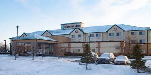 a large building with cars parked in a parking lot at Crystal Inn Hotel & Suites - Great Falls in Great Falls