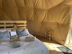 a bedroom with a bed in a tent at Cherry Tree Dome in Smeeth
