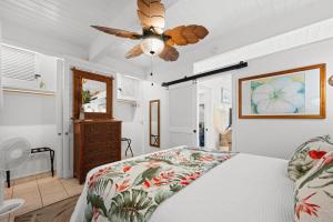 a bedroom with a bed and a ceiling fan at Kona Mansions#B217 Beautiful unit with Ocean view! in Kailua-Kona +26 photos