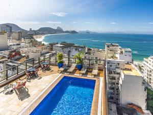 a view of the ocean from a building with a swimming pool at B&B HOTEL Rio Copacabana Posto 5 in Rio de Janeiro