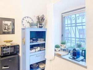 a kitchen with a window and a clock on the wall at Apartmán No 244 in Tábor