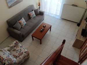 a living room with a couch and a coffee table at Galini in Mytikas