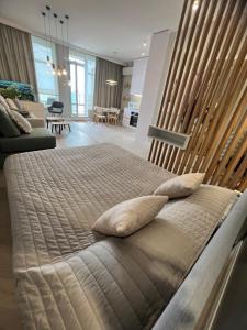 a large bed with two pillows in a bedroom at Апартаменты у моря Magnit первая линия in Odesa