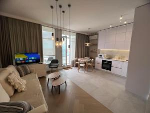 a living room with a couch and a table at Апартаменты у моря Magnit первая линия in Odesa