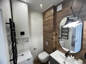 a bathroom with a sink and a mirror at Апартаменты у моря Magnit первая линия in Odesa +154 photos