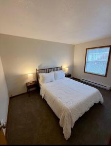 a bedroom with a large white bed with two lamps at Wildcat 4020 in Marion