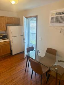 a kitchen with a glass table and chairs and a refrigerator at Wildcat 4020 in Marion +1 photo