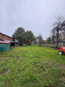 a field of grass with a red truck in it at Casa Maya Modern central and pet friendly in Futaleufú