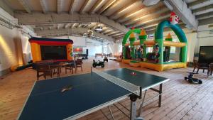 a room with a ping pong table in a room with a play area at 36 Mini Pod "Sorge" in Silberstedt