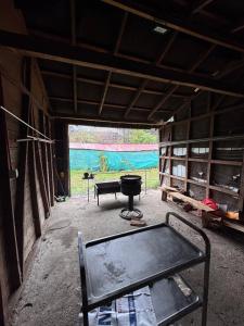 a room with a bed and a grill in a building at Casa Maya Modern central and pet friendly in Futaleufú