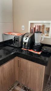 a kitchen counter with a microwave and a mixer on it at Casa na Serra Canto do Jair in Casimiro de Abreu