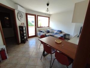 a living room with a couch and a table at Casa Nicole Aquileia in Aquiléia +12 photos
