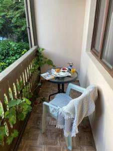 a small table with a plate of food on a balcony at Hotel "Tbilisi Tales" in the heart of the Old City in Tbilisi City