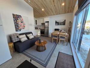 a living room with a couch and a table at Hebergement du grenier 2 0 in Notre-Dame-des-Monts